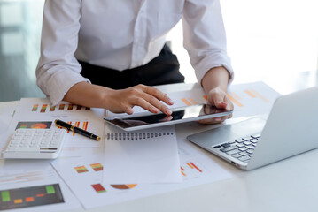 Close up of young businesswoman using digital tablet in the office.