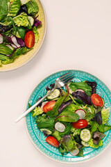 Two bowls of salad on white background. Tasty and healthy food concept. Flat lay..