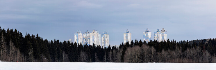 City beyond  forest. Perm