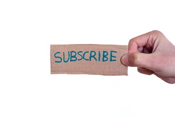 Hand holding cardboard box with subscribe text isolated on white background.