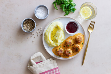 Swedish meatballs in cream sauce, potatoes and lingonberry sauce. Swedish cuisine. Recipe.