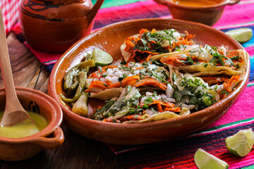 Mexican tacos al pastor accompanied by vegetables and sauces