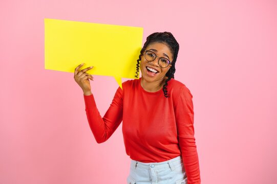 Don't Miss. Excited shocked black girl holding empty speech bubble, over pink studio wall, free space