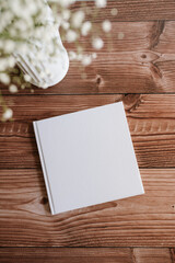 hardcover white book mock up on wooden table