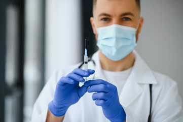 Medical doctor holds vaccine for a patient.