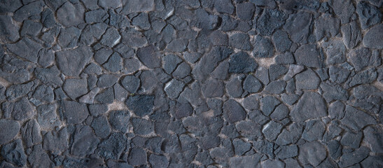 Black stone wall, volcanic stone background