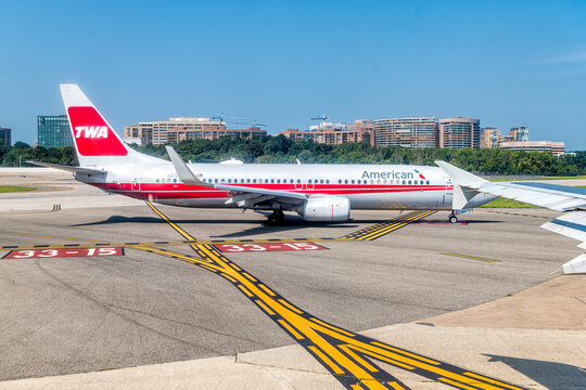 Washington DC, USA - August 25, 2021: Airplane window view of American Airlines in Washington DC Reagan Airport runway gate in Virginia with TWA sign as heritage plane