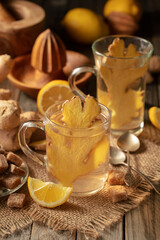 Fototapeta premium Ginger tea with ingredients on an old wooden table.