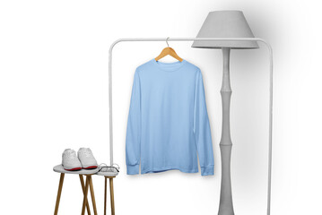 Blue long sleeve t-shirt on wooden hanger with property