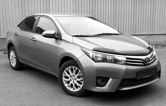 BIYSK, RUSSIA - OCTOBER 16.2019: Toyota Corolla 2014, car parked in a parking space. Black and white photography. 