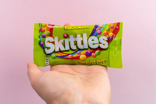 Tyumen, Russia-December 27, 2021: Skittles sweets brand is owned and produced by the Wrigley Company. Multicolored background