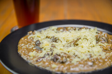 Tasty funghi risotto with meat and cheese
