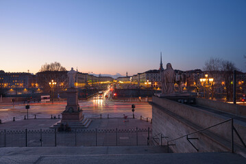 Fototapeta premium Turin, Italy. February 15, 2022. View at dusk from the starway of Gran Madre di Dio Church on the evening car traffic on Corso Casale and the Vittorio Emanuele I Bridge.