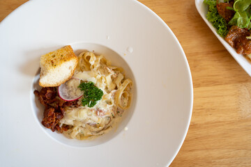 Pasta Spaghetti with black truffle, white mushroom, Cream Sauce and ricotta cheese. woonden background. Top view