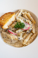 Pasta Spaghetti with black truffle, white mushroom, Cream Sauce and ricotta cheese. woonden background. Top view