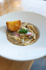 Pasta Spaghetti with black truffle, white mushroom, Cream Sauce and ricotta cheese. woonden background.