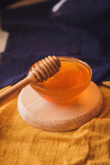 Thick sweet tasty honey in a bowl. Wooden spoon for honey. Sugar substitute. Natural sweetness.