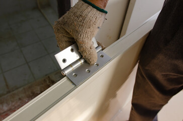 Construction worker installing a bathroom door