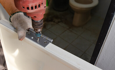 Construction worker installing a bathroom door