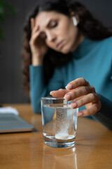 Ill business woman has problem with high or low blood pressure take medicines has to work in office instead of sick leave. Unwell female suffer from tension, headache on workplace, selective focus