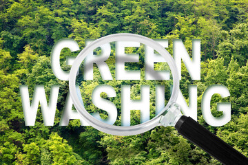 Alert to Greenwashing - concept with text against a forest and trees and magnifying glass