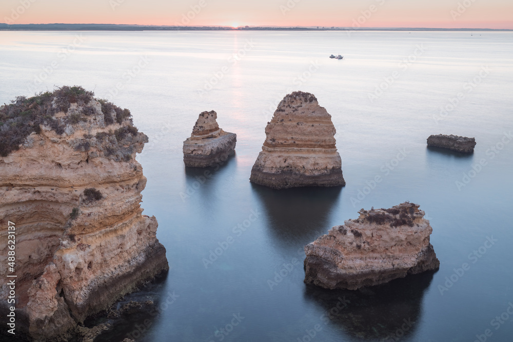 Wall mural coastal cliffs of algarve, lagoa, portugal summer season in most popular tourist region.