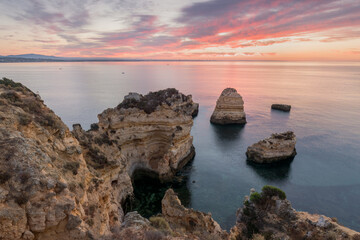 Coastal cliffs of Algarve, Lagoa, Portugal Summer season in most popular tourist region.