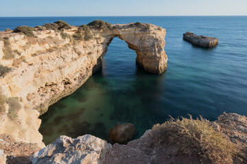 Fototapeta na wymiar Coastal cliffs of Algarve, Lagoa, Portugal Summer season in most popular tourist region.