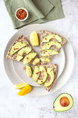 Crisp rye bread sandwiches with avocado slices