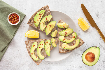 Crisp rye bread sandwiches with avocado slices