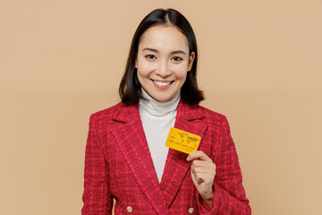 Smiling happy cheerful satisfied woman of Asian ethnicity 20s wear red jacket hold in hand credit...