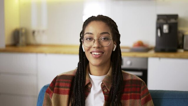 Portrait beautiful african american woman smiling looking happy feeling confident, wearing earphones