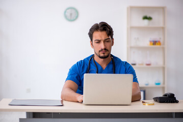 Young male doctor working in the clinic