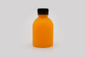 orange juice in a bottle isolated on a white background