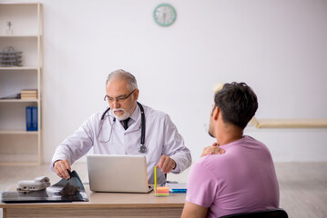 Young male patient visiting old male doctor radiologist