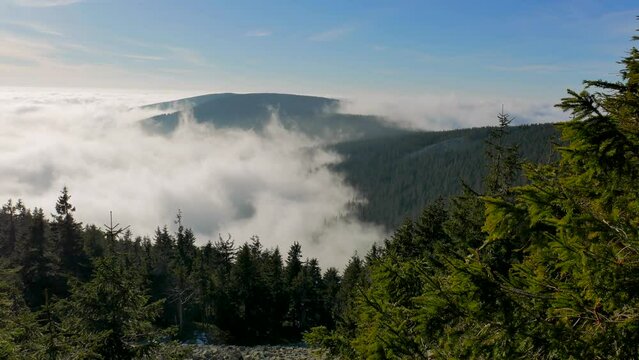 Low rolling mist in a valley between green mountains.