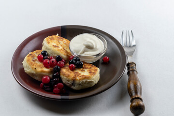 Syrniki or syrniki with cottage cheese and currant berries. Healthy breakfast concept. Delicious dessert or sweet breakfast.