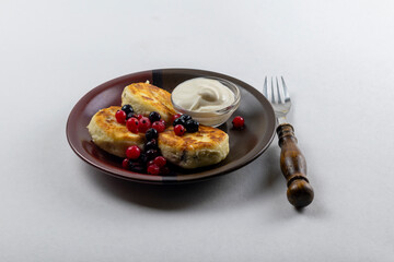 Syrniki or syrniki with cottage cheese and currant berries. Healthy breakfast concept. Delicious dessert or sweet breakfast.