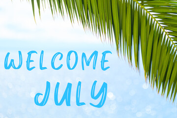 Fototapeta na wymiar Welcome July text on the background with palm leaf and blue sea. Template of a greeting card, postcard or advertisement of a tour agency. 