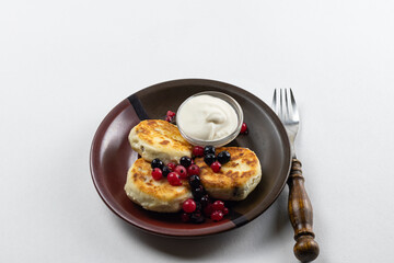 Syrniki or syrniki with cottage cheese and currant berries. Healthy breakfast concept. Delicious dessert or sweet breakfast.