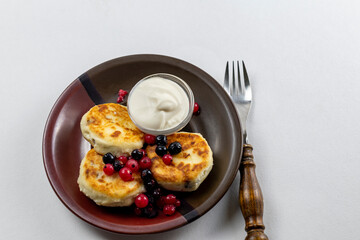 Syrniki or syrniki with cottage cheese and currant berries. Healthy breakfast concept. Delicious dessert or sweet breakfast.