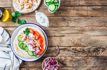 Healthy diet Gyros, greek pita bread wrapped sandwich with meat slices, tzatziki and fresh vegetables.