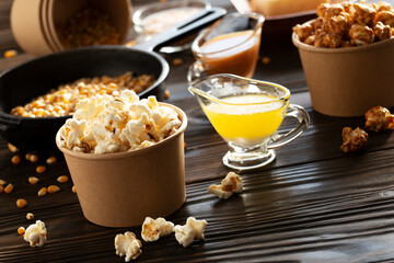 Paper buckets with butter and caramel popcorn on kitchen table