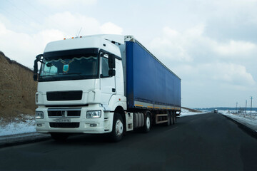 Fototapeta na wymiar White semi trailer lorry truck passing highway driving