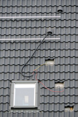 Installation of a mounting structure and the electrical wiring for solar panels on a roof of a house