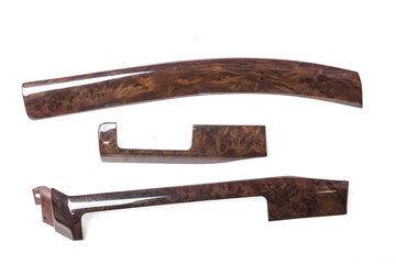 decorative overlay of the panel and doors of the car interior from the root of the walnut tree in brown color.