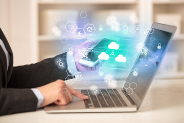 Obraz premium Hands working on laptop with digital icons