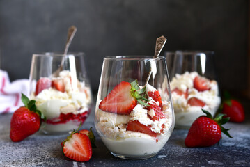 Traditional english dessert eton mess with meringue, whipped cream and fresh berries.
