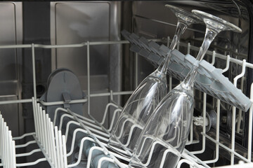 Glasses dishes in the dishwasher. Homework with dishwasher concept