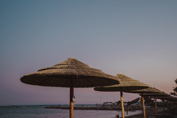 umbrellas on the beach at sunset